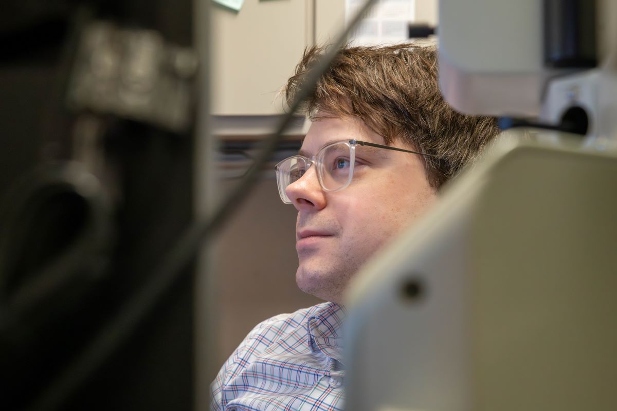 Dr. Robert Bell examines test results in his office.